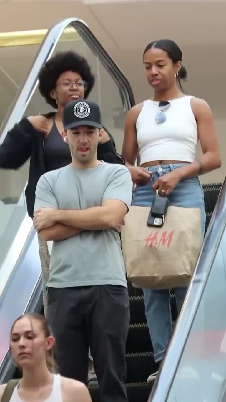 Man Repeats the Same Question Until Two Shoppers Freeze on Escalator
