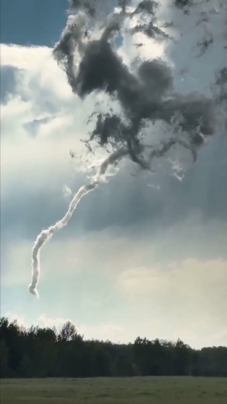 Canada Skies: A Rope-Like Funnel Spins Over an Open Field