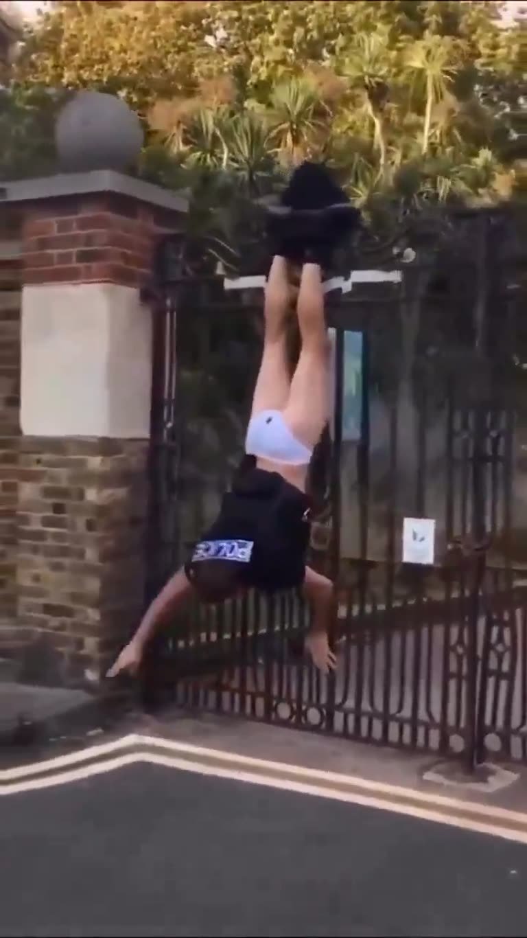 Figure in POLICE Gear Left Dangling Upside Down on a Gate
