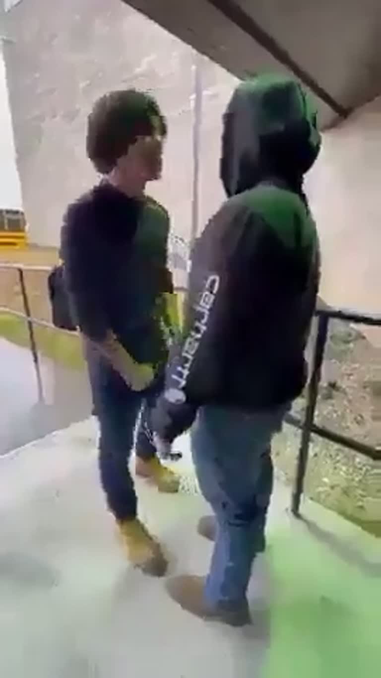 Outside a School, Two Students Square Off as a Bus Waits