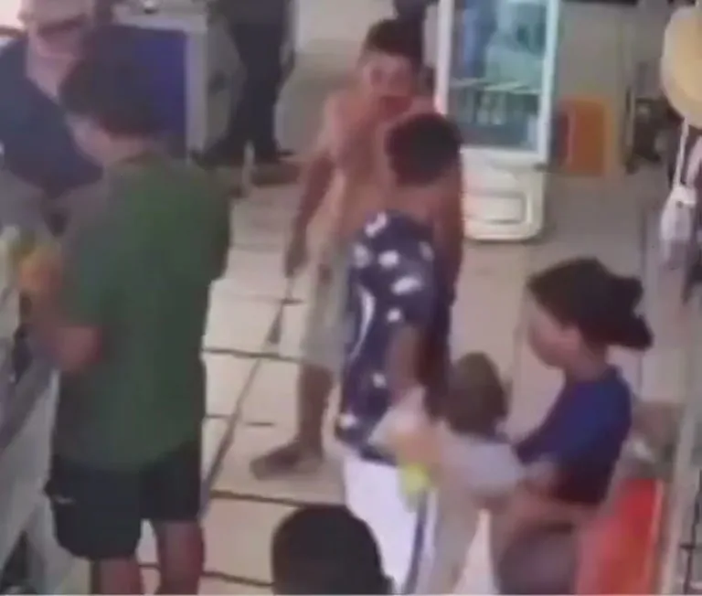 Shirtless Man Holding a Small Child Draws a Crowd in Store
