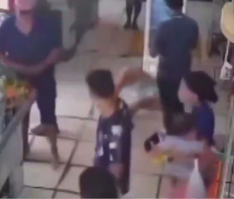 Shirtless Man Holding a Small Child Draws a Crowd in Store