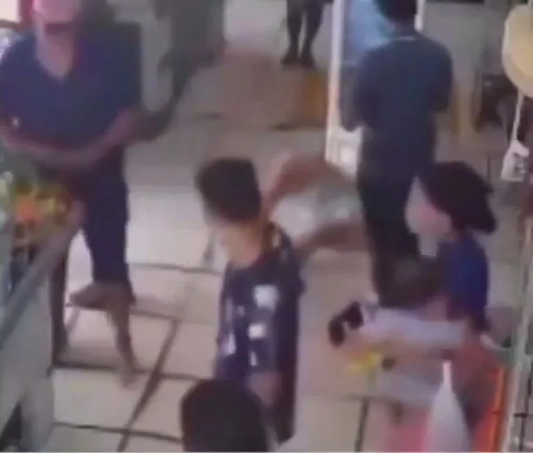 Shirtless Man Holding a Small Child Draws a Crowd in Store