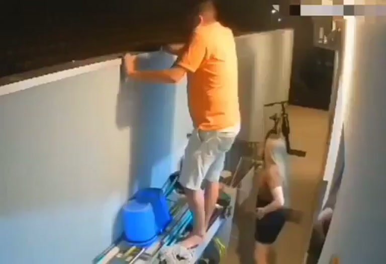 Man Climbs Shelf in Hallway Before the Whole Thing Gives Way