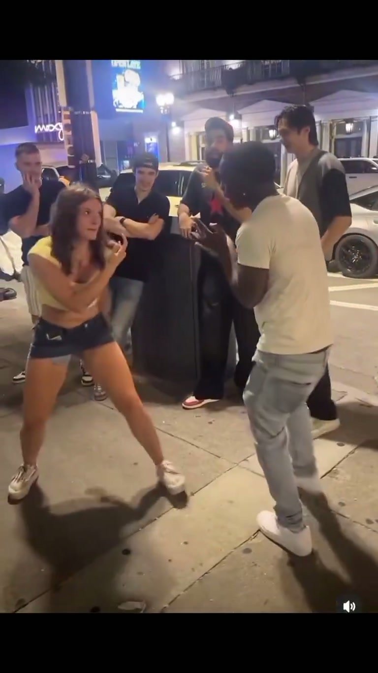 She drops into a boxer's stance — and the street goes quiet